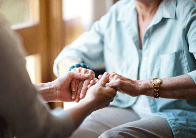 senior woman holding hands